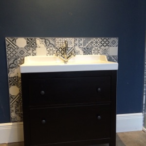 vanity unit with decorative tiled surround installed in a bathroom in Norwich